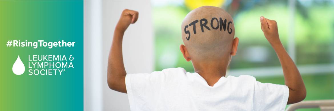 A young male cancer patient with a shaved head on which is written the word strong
