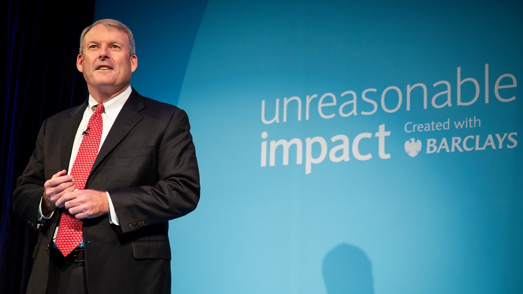 Joe McGrath, Chairman of Banking, on stage at an Unreasonable Impact event