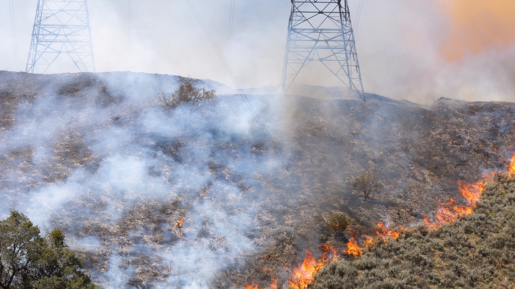 A wildfire threatens electricity pylons in America