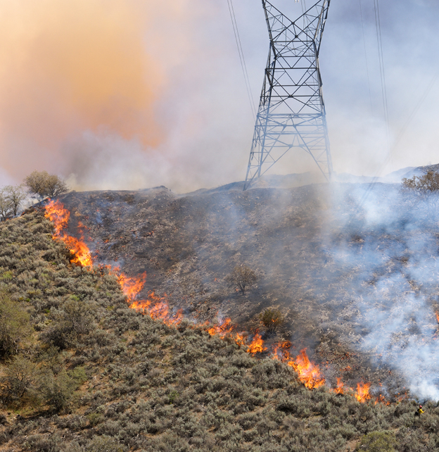 A wildfire threatens electricity pylons in America